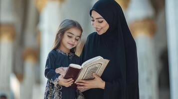 Muslim mother and daughter reading a holy book together photo