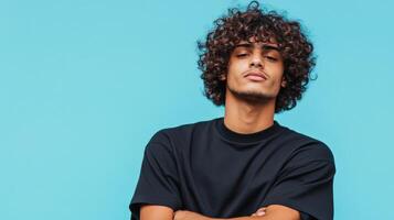 Young Man with Curly Hair Posing Against a Blue Background photo