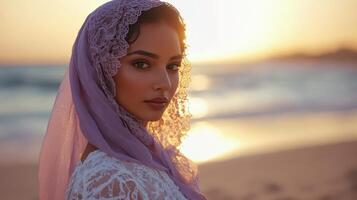 Woman in Lace Headscarf at Sunset Beach photo