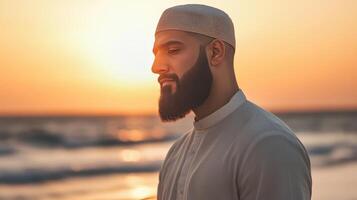 Muslim Man Contemplates at Sunset Ocean Beach photo