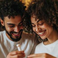A man and woman are smiling while holding a toothbrush photo