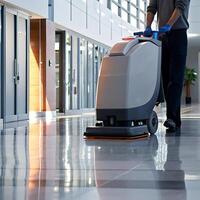 professional floor cleaning machine being used by a worker in a modern building hallway photo