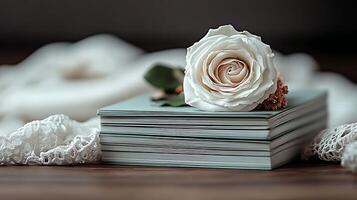 un enfoque suave imagen de apilado libros adornado con un blanco rosa, conjunto en contra un borroso fondo, ideal para literario temas foto