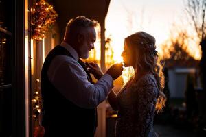 Couple stands in front of mirror one adjusting other's tie in warmly lit space capturing tender and intimate moment. Love and connection radiate between them photo
