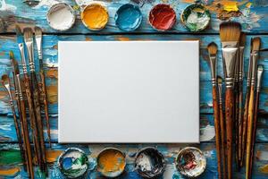 top down view showcases composition of art supplies arranged neatly on rustic wooden table. Paintbrushes colorful palettes and blank canvas invite creativity and artistic expression photo