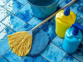 Brightly colored cleaning supplies are organized on shiny tiled floor. mop and bucket dominate view showcasing commitment cleanliness and order in work environment photo