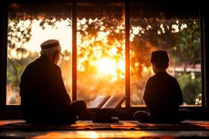 elderly man and young boy focus on their prayers together in serene home prayer space. Quran is open on wooden stand surrounded warm ambient light as sun sets photo