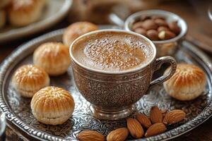 beautifully arranged silver tray features cup of Arabic coffee alongside freshly baked maamoul photo
