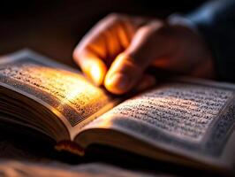 Candlelight gently illuminates hands raised in Dua while open Quran reveals intricate Arabic calligraphy capturing spiritual essence of Eid al Fitr celebrations photo