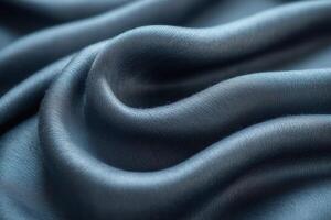 Close-up of luxurious, dark blue satin fabric with smooth, flowing curves. photo