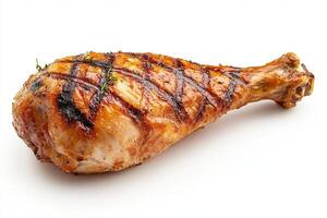 Juicy grilled chicken leg with a crispy exterior and grilling marks, garnished with fresh thyme. photo