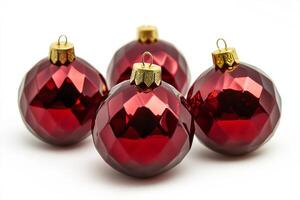 Four shiny red Christmas ornaments with gold tops, perfect for festive decorations. photo