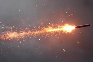 A close-up shot of a sparkler igniting in the darkness, creating a trail of bright sparks and glowing embers. photo