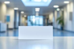A blank white card sits on a table against a softly blurred office background, creating an atmosphere of professionalism and simplicity. photo