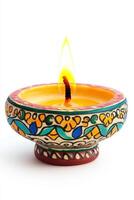 A vibrant, decorative oil lamp with intricate patterns, glowing warmly with a flickering flame. photo