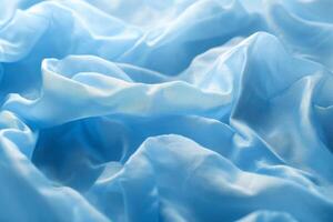 Delicate blue fabric draped elegantly, showcasing soft textures and folds. photo
