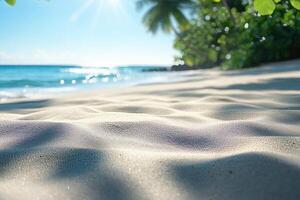 A tranquil beach scene showcasing soft, sunlit sand with gentle waves lapping in the background under a clear blue sky. photo