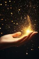 A human hand releasing a shower of shimmering golden particles against a dark background, creating a magical atmosphere. photo