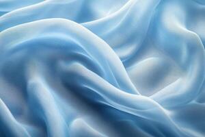 Delicate light blue silk fabric with soft folds and waves, creating a serene and elegant texture. photo