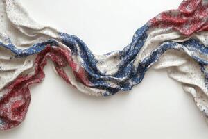 A draped fabric featuring red, white, and blue hues, creating a sense of movement and texture. photo