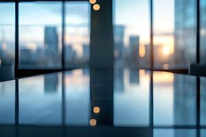A sleek boardroom table reflects the sunset through large windows, creating a serene atmosphere for meetings. photo