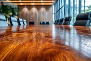 A sleek boardroom features a polished wooden table, reflecting modern design with surrounding leather chairs. photo