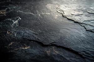 Close-up of dark textured stone surface with intricate patterns and natural veining, showcasing rugged beauty. photo