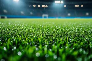 Close-up of vibrant green artificial turf in a rain-soaked stadium, highlighting droplets of water reflecting bright stadium lights. photo