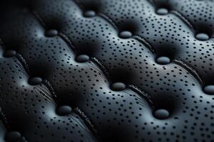 Close-up of a luxurious black leather upholstery with intricate perforations. photo