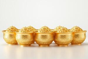 A collection of intricately designed golden bowls, showcasing elegance and luxury in a bright setting. photo