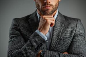 Thoughtful man in a stylish suit pondering, displaying confidence and professionalism. photo