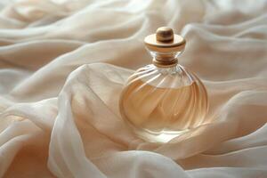 Elegant glass perfume bottle resting on soft, draped fabric in warm tones. photo