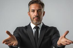 A confident Middle-Eastern man in a suit extends his hands, inviting connection and engagement. photo