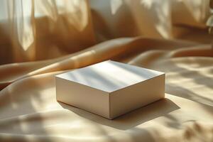 A simplistic, elegant white box rests on a soft, golden fabric, illuminated by gentle sunlight filtering through sheer curtains. photo