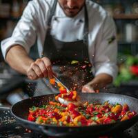 A male chef expertly tosses colorful vegetables in a sizzling pan, creating a burst of flavors in a vibrant kitchen setting. photo
