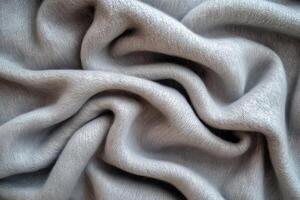 Soft, textured folds of light gray fabric create a cozy, inviting atmosphere. photo