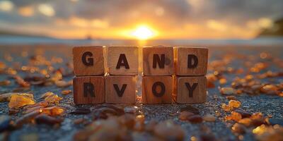 Wooden blocks spelling 'GANDRVOY' on a beach at sunset, surrounded by shimmering stones. photo