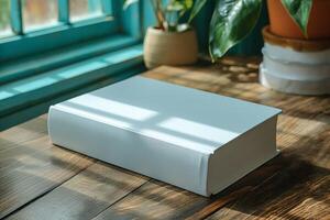 A clean, blank book rests on a rustic wooden table, illuminated by soft sunlight filtering through turquoise windows. photo