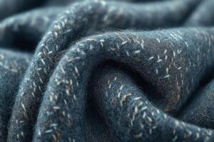 Close-up of a textured wool fabric showcasing intricate stitching details in subtle gray tones. photo
