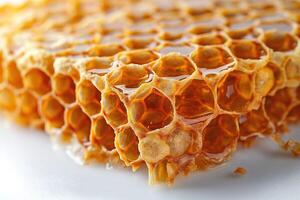 Close-up of golden honeycomb dripping with rich, sweet honey, showcasing its intricate hexagonal structure. photo