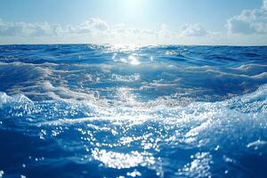 A serene ocean view, with shimmering blue waves and soft white foam reflecting the sunlight, creating a tranquil atmosphere. photo