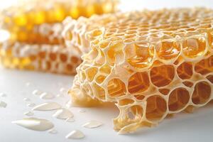 Glistening honeycomb with golden honey droplets reflecting light, evoking a sense of natural sweetness. photo