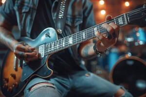A male musician passionately strums an electric guitar in a cozy, dimly lit space, surrounded by instruments. photo