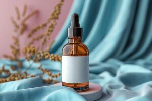 Amber glass bottle with dropper on soft teal fabric, surrounded by dried foliage, creating a serene and elegant atmosphere. photo