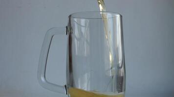 The Correct Method of Pouring Beer with the Right Head of Foam into a Classic Glass with Handle. Beer Pouring into Empty Pint Beer Mug Isolated on White video
