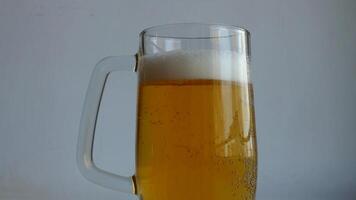 Full Beer Tankard of Rich Color Classic Beer and Cool Foam Level in 4K Resolution. Bubbles on the thick walls of a glass of beer rise up and form a foamy cap closeup video