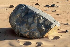 A large rock in the middle of a desert photo