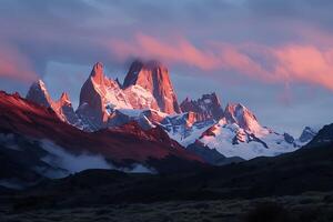 The mountains are covered in snow and clouds photo