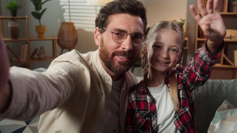 Web cam view call app conference vlog online blog Caucasian family middle-aged man dad father with little girl child kid daughter with teddy bear smiling hello greeting talking to camera at home 56660215 Stock Video at Vecteezy