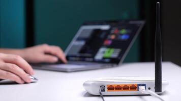 Programmer connecting to internet using wireless router and laptop video
